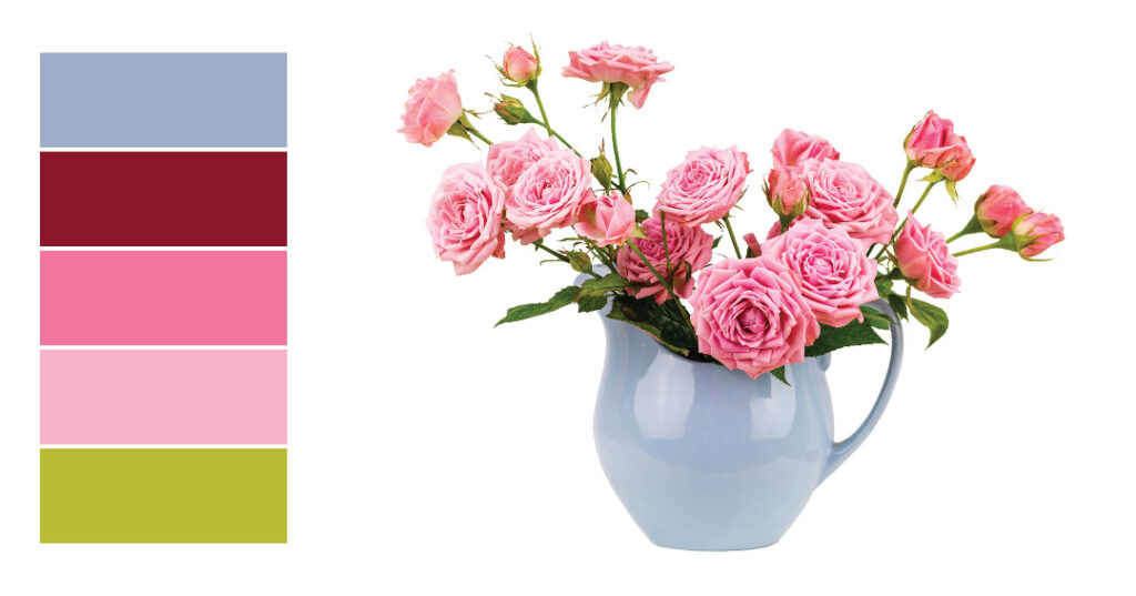 Color palette beside a blue vase filled with pink roses.