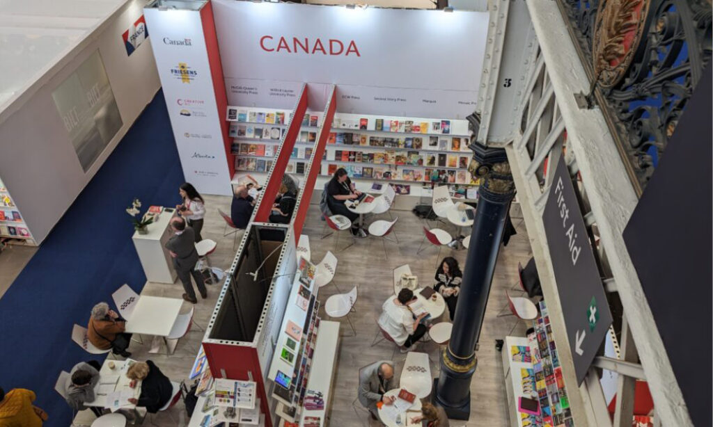 Overhead view of the Canada booth with books, tables, and attendees at the London Book Fair.