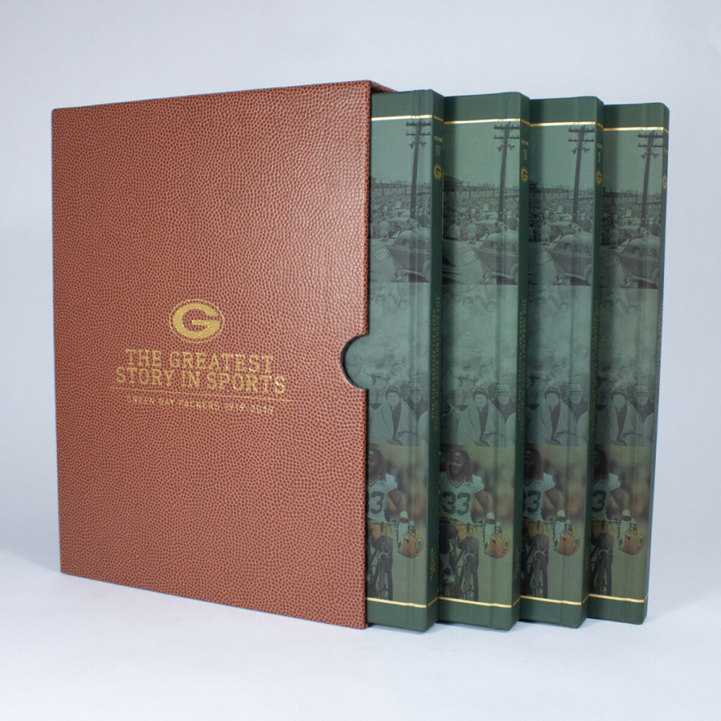Four-volume sports history book set displayed beside a textured brown slipcase with gold lettering.