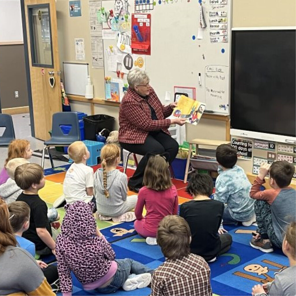 teacher reading book to students