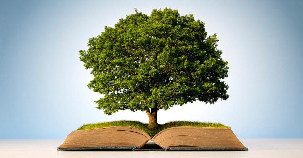 Large green tree emerging from an open book against a light blue background