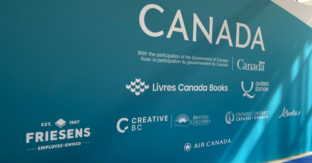 Large blue Canada pavilion wall featuring sponsor logos and government participation text.