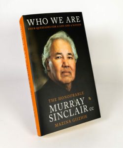 Book titled “Who We Are” with a dark background and gold text accents.
