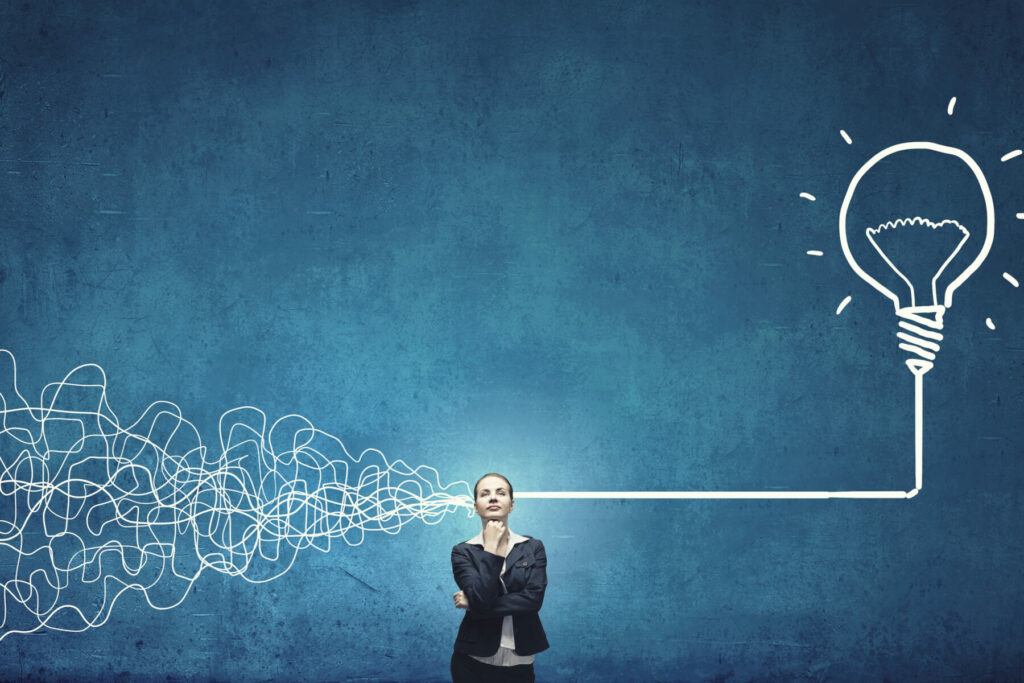 Person standing before a tangled line that transforms into a bright lightbulb on a blue background.