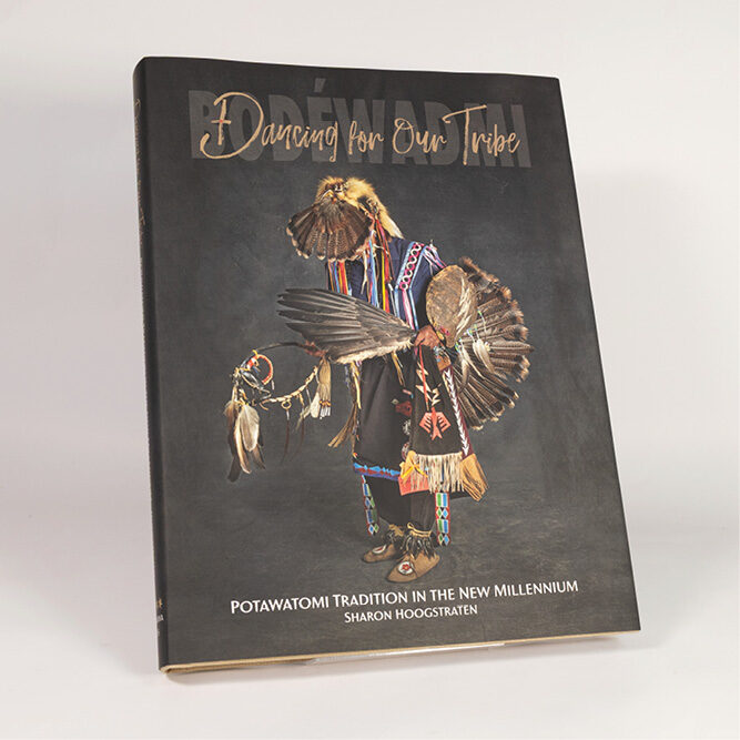 Book titled “Dancing for Our Tribe” featuring a dancer in traditional Potawatomi regalia on a dark background.