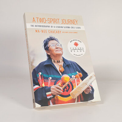 Book cover of A Two‑Spirit Journey featuring a person in traditional clothing holding cultural items