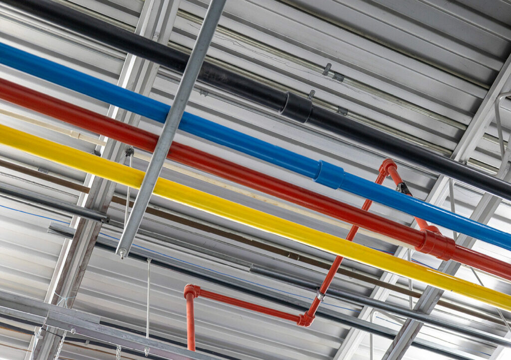 Series of coloured pipes to deliver ink to a press