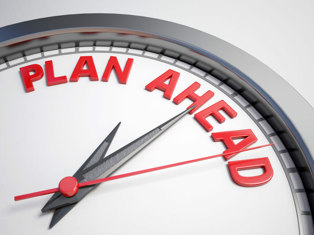 Close-up of a clock-style graphic with the words “PLAN AHEAD” in bold red letters above the clock face.
