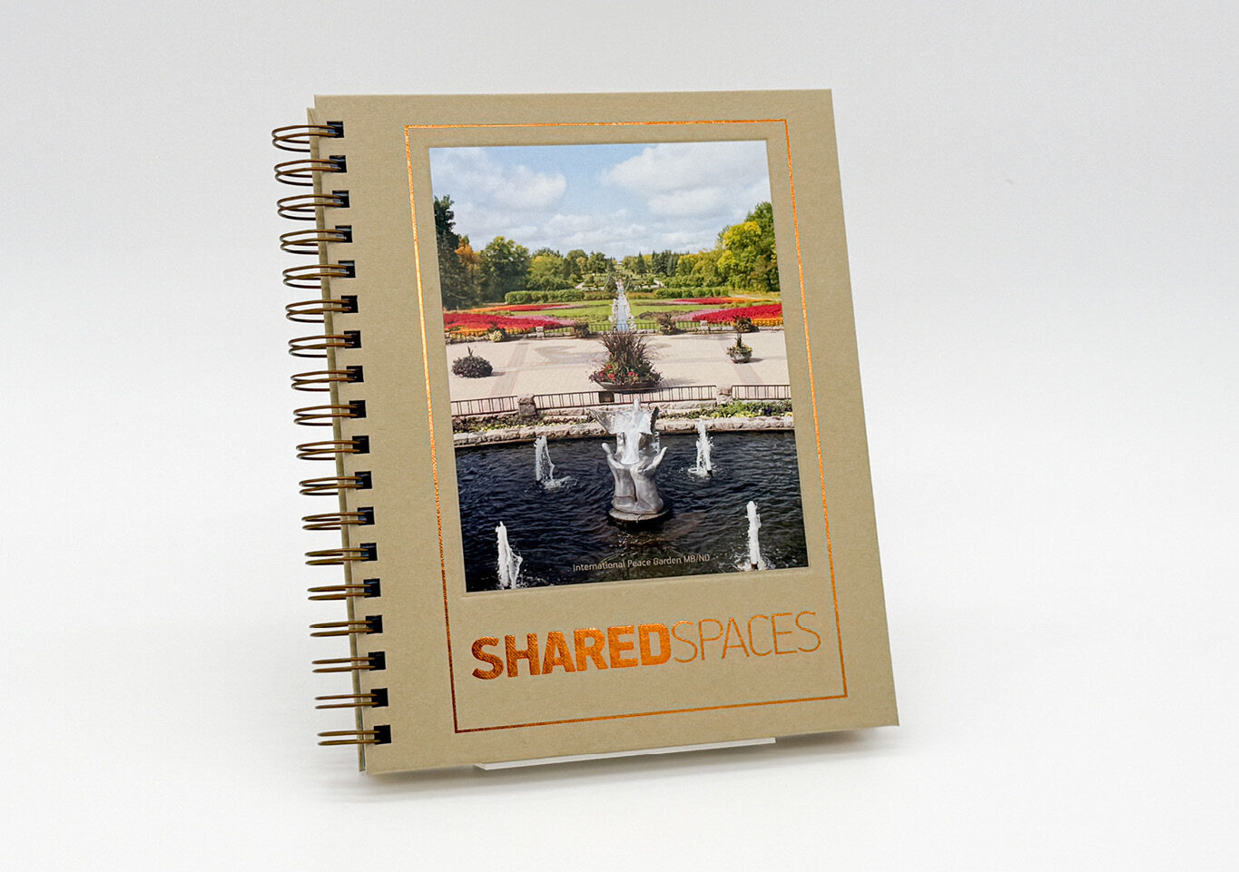 Image of a wire-o bound journal with the International Peace Gardens on the cover