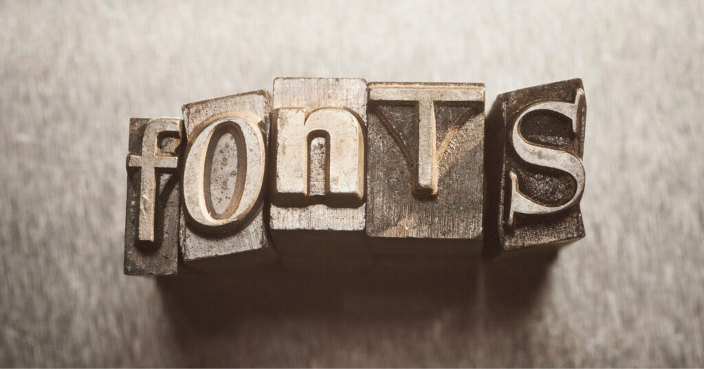 Metal letterpress blocks arranged to spell the word “fonts.”