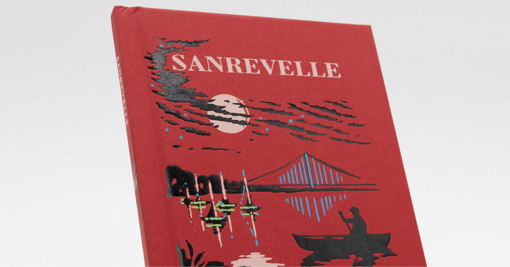 A red hardcover book featuring an illustrated night scene with a full moon, clouds, a bridge, and a person paddling a canoe.