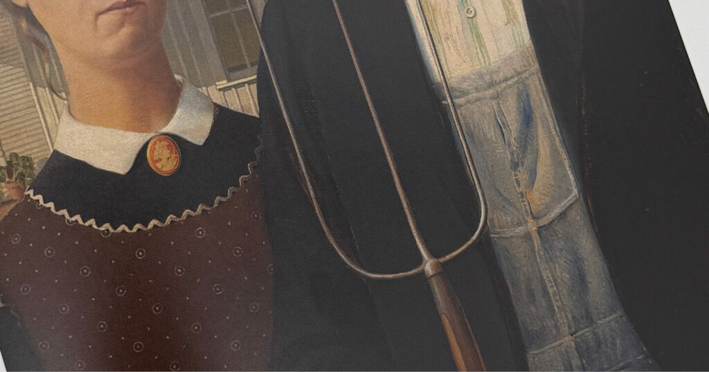 Partial view of the “American Gothic” painting, showing the figures’ clothing and a pitchfork.