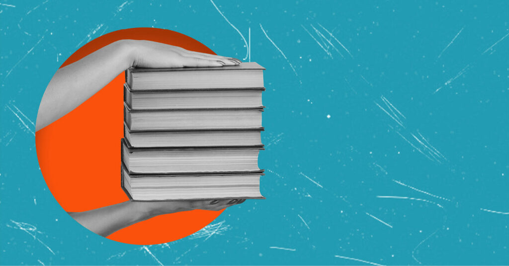 A pair of hands holding a tall stack of books against a blue background with an orange circle behind the books.