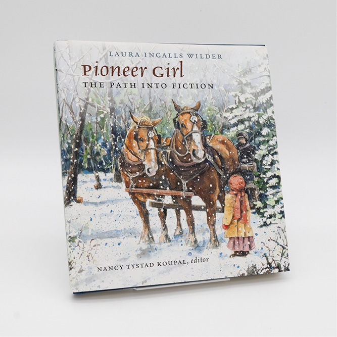Cover of the book Pioneer Girl: The Path Into Fiction, featuring an illustrated winter scene with two horses pulling a wagon and a girl standing beside them.