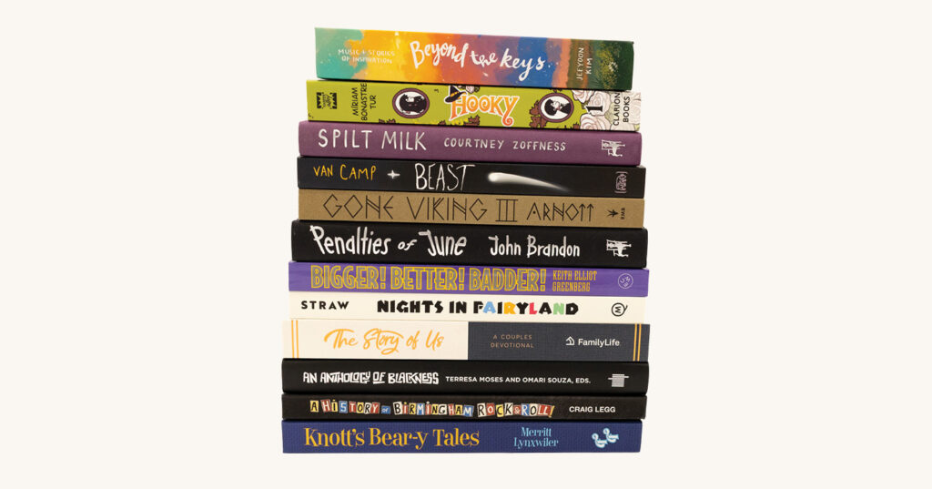 A tall stack of 14 books arranged in a column, featuring brightly colored spines with varied titles and designs.