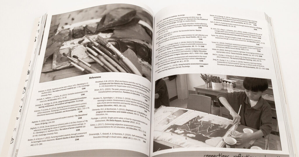 Open book spread showing black-and-white photos of paintbrushes, reference text, and an artist working on a printmaking project.