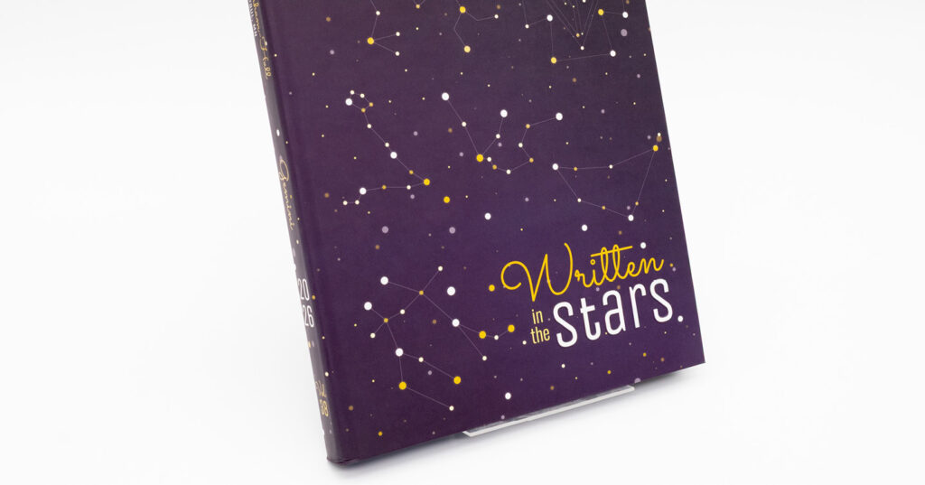 Purple yearbook cover featuring constellation artwork and the title 