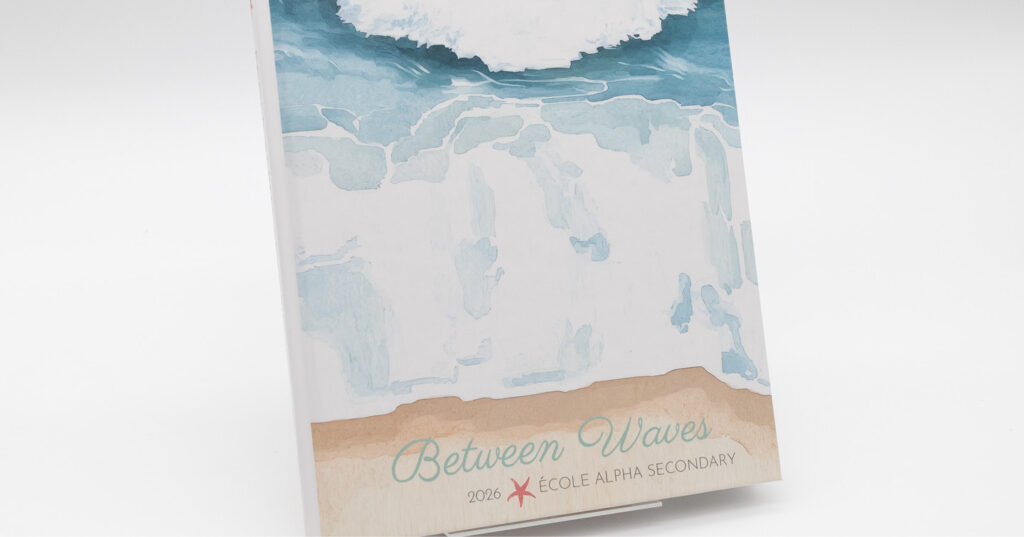 Beach-themed yearbook cover with ocean waves artwork and gritty lamination that adds a sand-like texture.