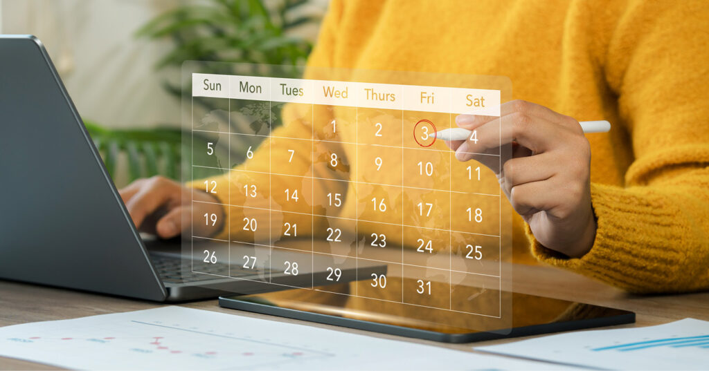 Person planning on a tablet beside a laptop, with a digital calendar overlay highlighting an important date.