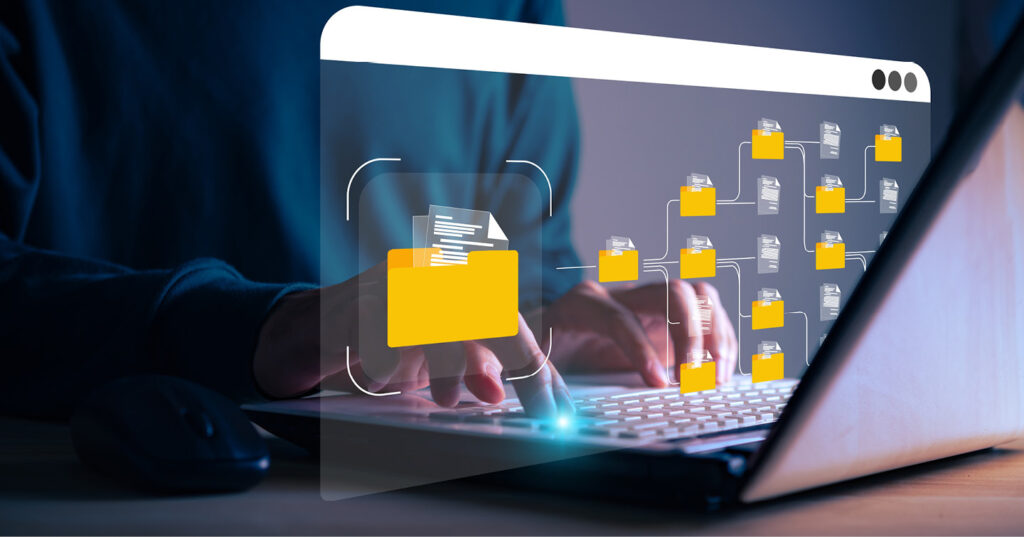 Person using a laptop with digital folders and documents displayed, illustrating organized file management.