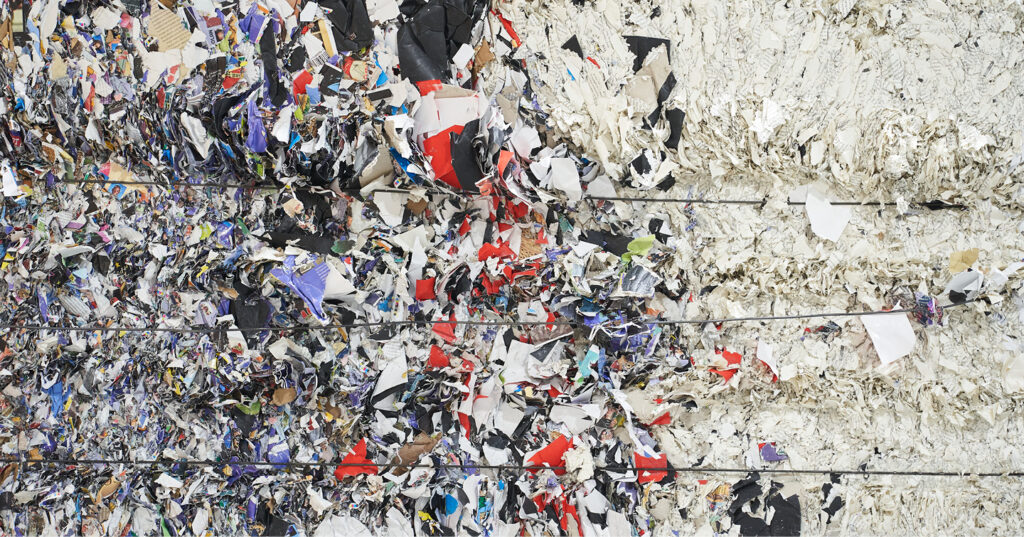 Bales of shredded and compressed paper waste and printed materials prepared for recycling and repurposing.