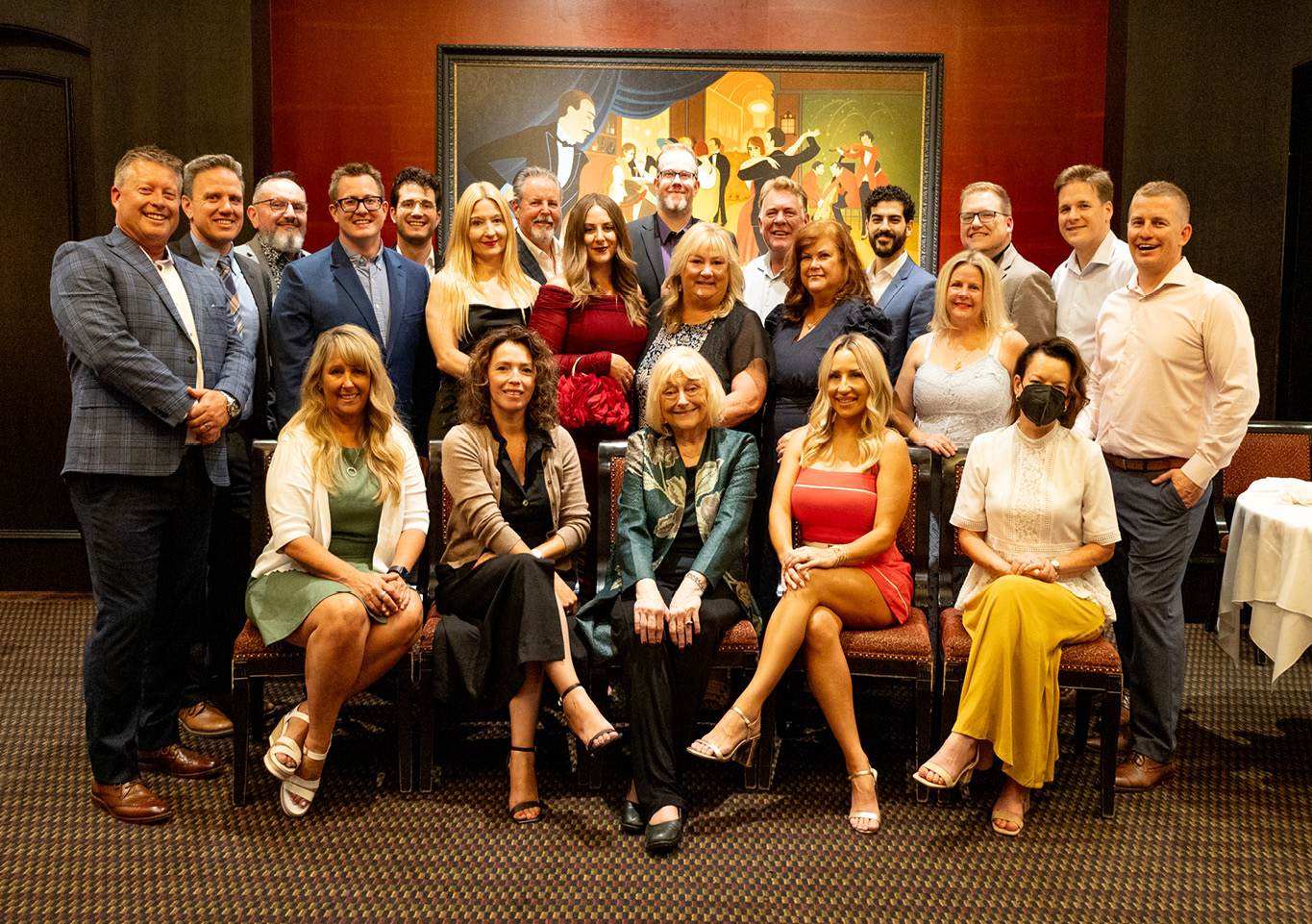 Yearbook sales team gathered for a group photo at a company event with formal and business attire.