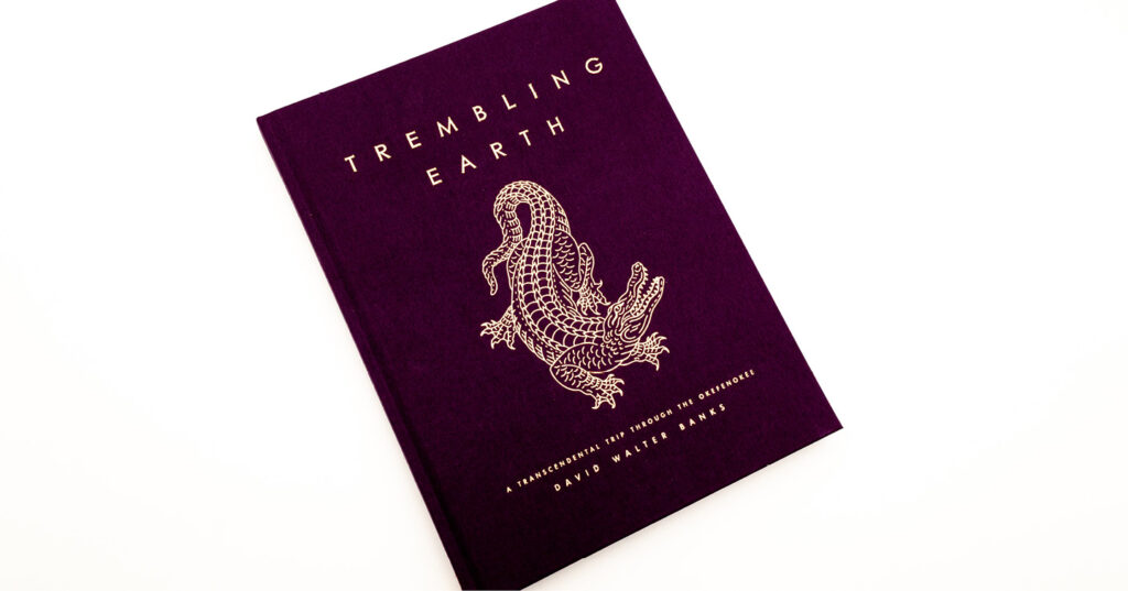 Purple hardcover book titled Trembling Earth with a gold-foil alligator illustration and lettering on the cover.